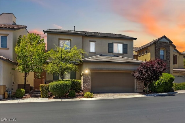 view of front of house featuring stucco siding and an attached garage