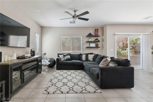 living room with light tile patterned floors and ceiling fan