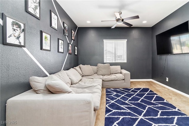 carpeted living area with a ceiling fan, healthy amount of natural light, recessed lighting, and a textured wall