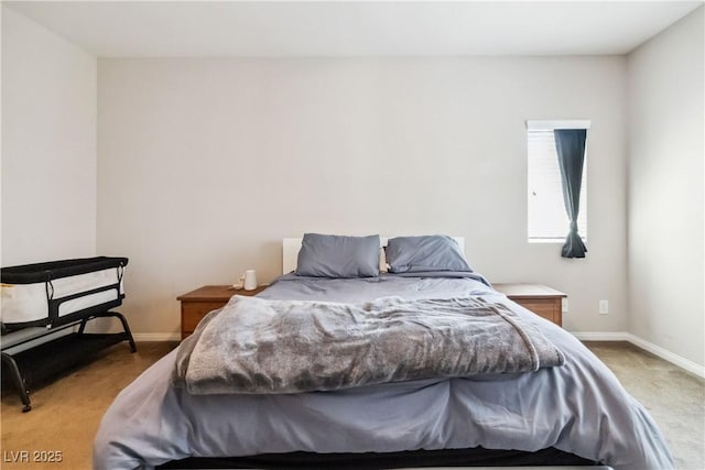 bedroom with light colored carpet and baseboards