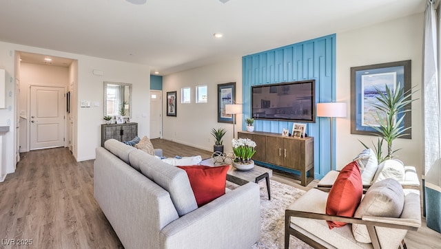 living room featuring light wood-style floors, baseboards, and recessed lighting