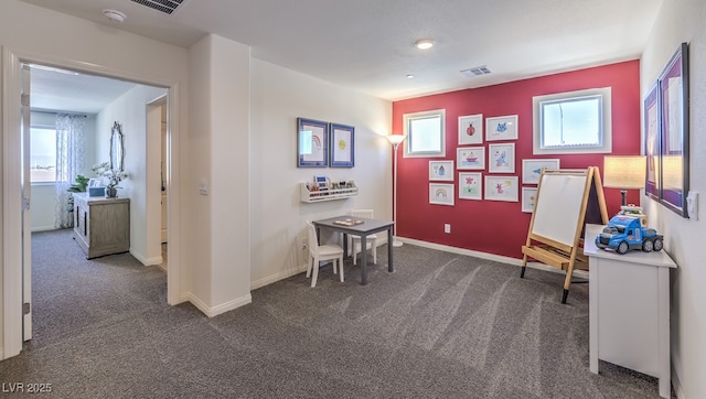 sitting room featuring baseboards, dark colored carpet, and visible vents