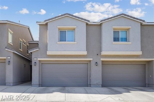 4465 Shimmering Skies St Unit 1177, North Las Vegas, NV 89031 - view of front of home featuring a garage, stucco siding, and driveway