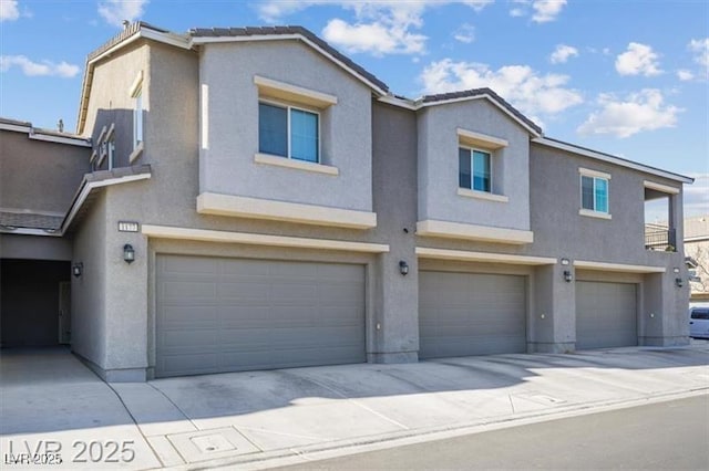 4465 Shimmering Skies St Unit 1177, North Las Vegas, NV 89031 - townhome / multi-family property featuring an attached garage, stucco siding, and concrete driveway