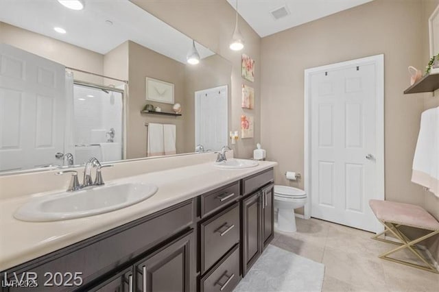 4465 Shimmering Skies St Unit 1177, North Las Vegas, NV 89031 - bathroom featuring double vanity, a sink, a stall shower, and toilet