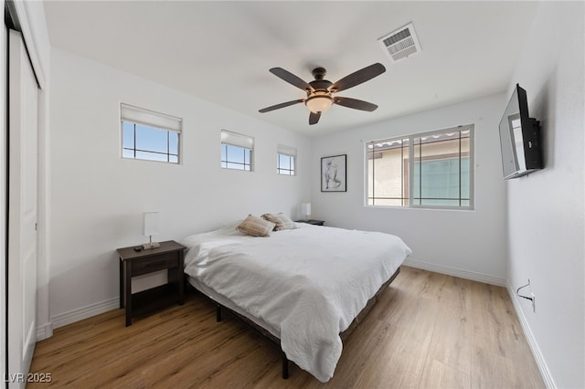 2606 Marvel Astoria St, Henderson, NV 89044 - bedroom featuring baseboards, light wood-style flooring, ceiling fan, and visible vents