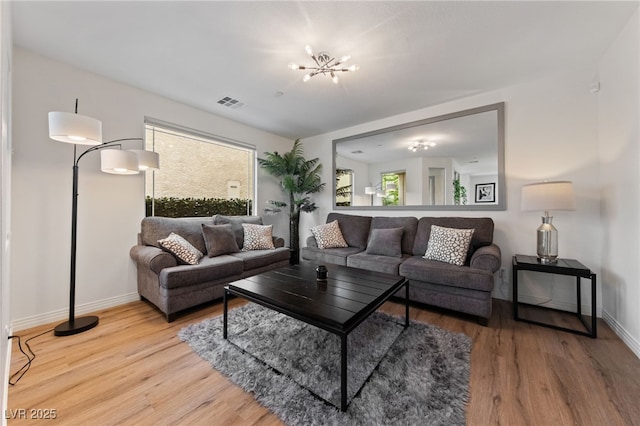 2606 Marvel Astoria St, Henderson, NV 89044 - living area featuring visible vents, light wood-style flooring, baseboards, and a chandelier