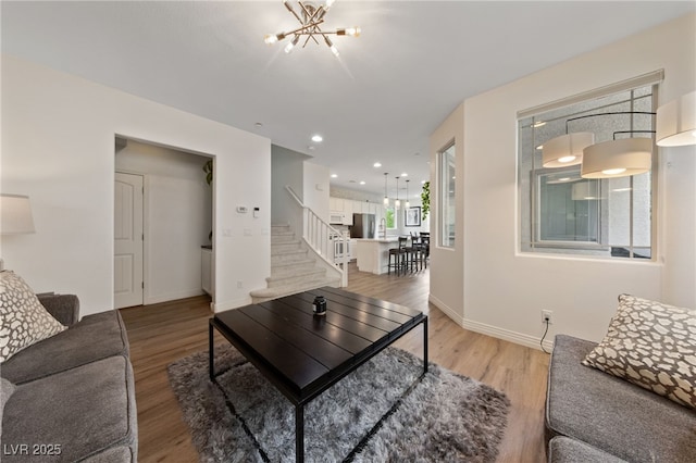 2606 Marvel Astoria St, Henderson, NV 89044 - living area with an inviting chandelier, light wood finished floors, recessed lighting, baseboards, and stairway
