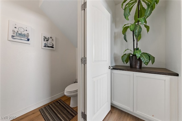 2606 Marvel Astoria St, Henderson, NV 89044 - bathroom with baseboards, wood finished floors, vaulted ceiling, and toilet