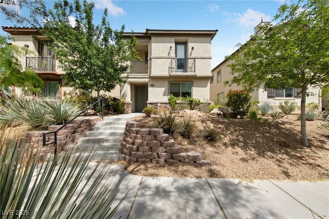 2606 Marvel Astoria St, Henderson, NV 89044 - view of front of home with a balcony, stone siding, and stucco siding