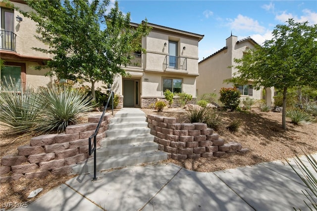 2606 Marvel Astoria St, Henderson, NV 89044 - view of front of home featuring stucco siding, a balcony, and stone siding