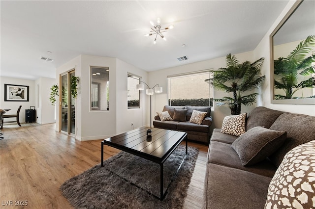 2606 Marvel Astoria St, Henderson, NV 89044 - living room featuring visible vents, baseboards, a notable chandelier, and light wood-type flooring