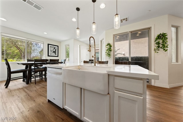 2606 Marvel Astoria St, Henderson, NV 89044 - kitchen with a sink, visible vents, wood finished floors, and dishwasher