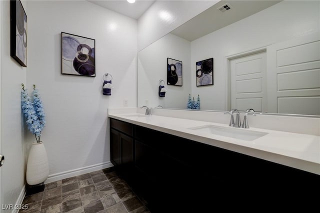 242 Polaris Ridge Ave, Henderson, NV 89011 - bathroom with double vanity, visible vents, baseboards, and a sink