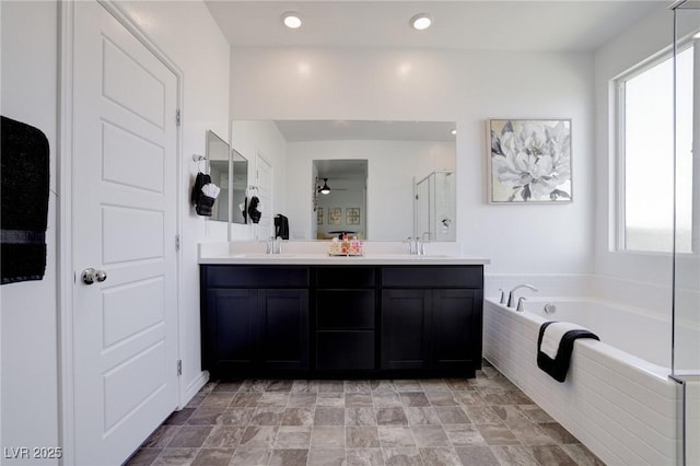 242 Polaris Ridge Ave, Henderson, NV 89011 - full bath featuring a shower stall, a garden tub, double vanity, and a ceiling fan