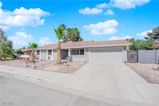 single story home featuring driveway, fence, an attached garage, stucco siding, and a gate