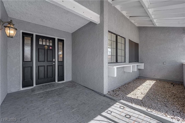 property entrance with stucco siding