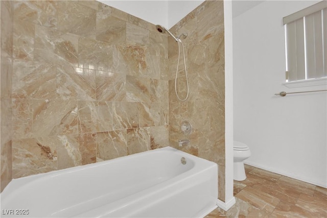 bathroom featuring toilet and shower / bathing tub combination