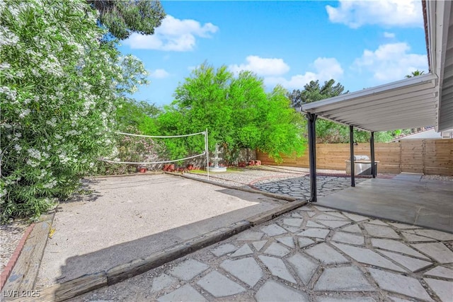 view of patio with a fenced backyard and volleyball court