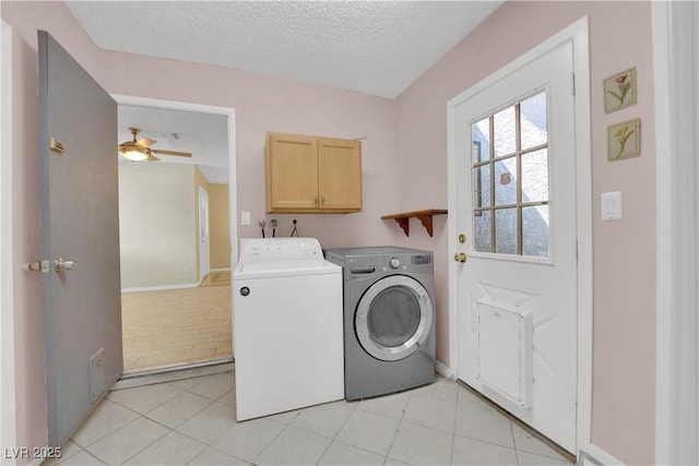 laundry room featuring cabinet space, a textured ceiling, light tile patterned flooring, separate washer and dryer, and ceiling fan