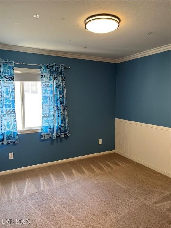 10974 Fintry Hills St, Las Vegas, NV 89141 - spare room featuring ornamental molding, carpet, and a wainscoted wall