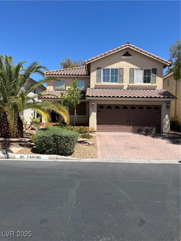 10974 Fintry Hills St, Las Vegas, NV 89141 - mediterranean / spanish-style house with a tiled roof, an attached garage, stucco siding, and decorative driveway