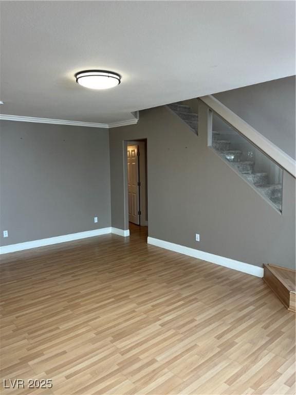 10974 Fintry Hills St, Las Vegas, NV 89141 - empty room with light wood-type flooring, baseboards, crown molding, and stairway