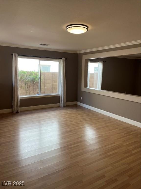 10974 Fintry Hills St, Las Vegas, NV 89141 - spare room featuring baseboards, ornamental molding, wood finished floors, and visible vents