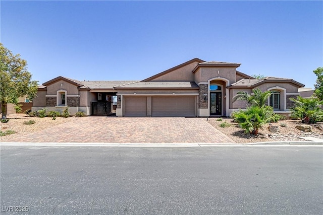 mediterranean / spanish-style house featuring stucco siding, driveway, and a garage