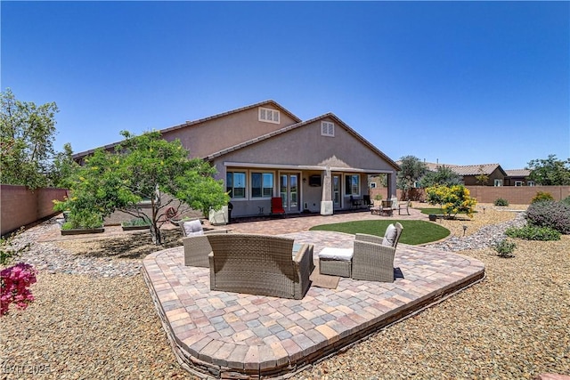 back of house featuring a fenced backyard, stucco siding, and a patio area
