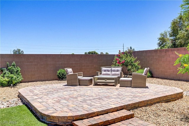 view of patio featuring fence and an outdoor hangout area