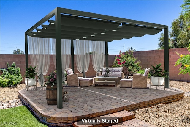 view of patio with an outdoor living space and a fenced backyard