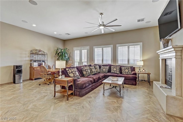 living area featuring visible vents, a ceiling fan, recessed lighting, and a fireplace