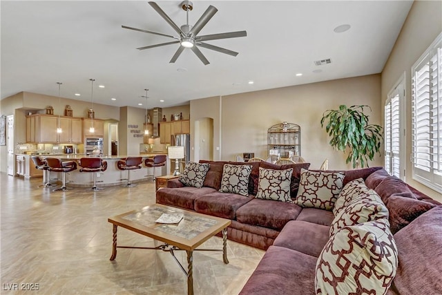 living area featuring a ceiling fan, visible vents, and recessed lighting