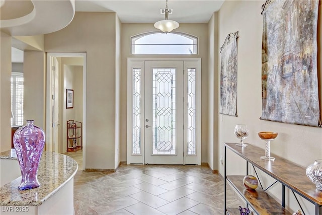 foyer entrance featuring baseboards