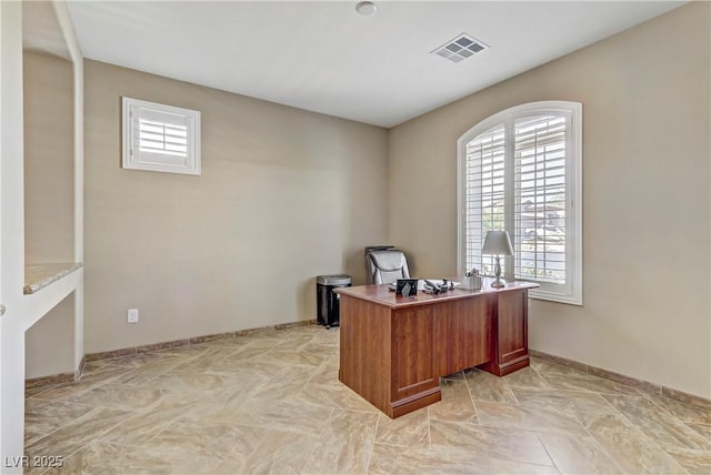 office area with baseboards, visible vents, and plenty of natural light