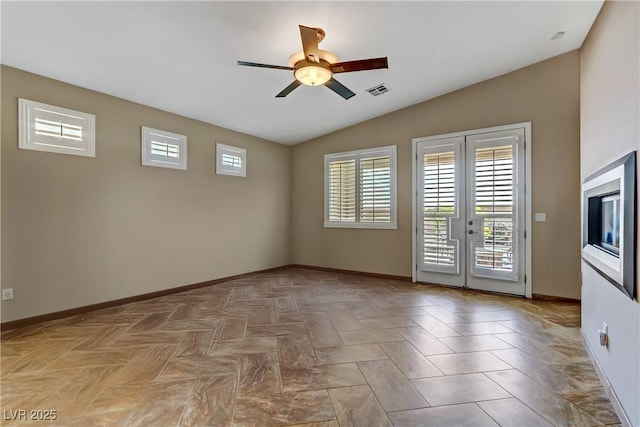empty room with vaulted ceiling, plenty of natural light, french doors, and ceiling fan