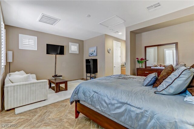 bedroom featuring attic access and visible vents