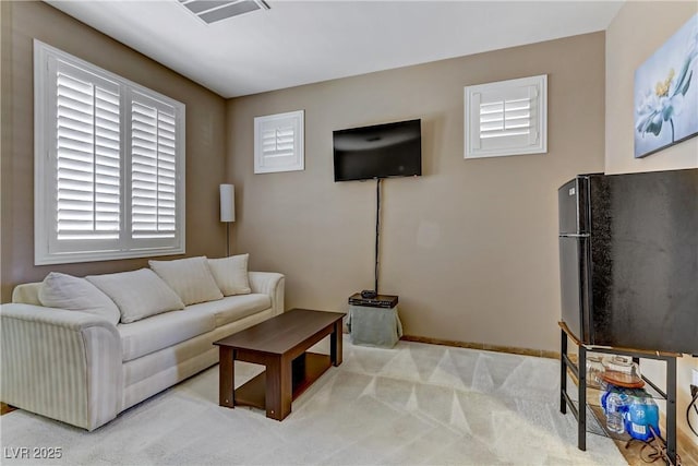 carpeted living room with baseboards