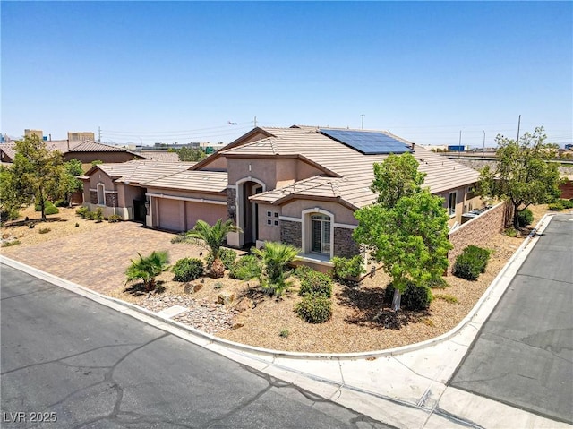 view of front of house with an attached garage, stucco siding, driveway, and a tile roof