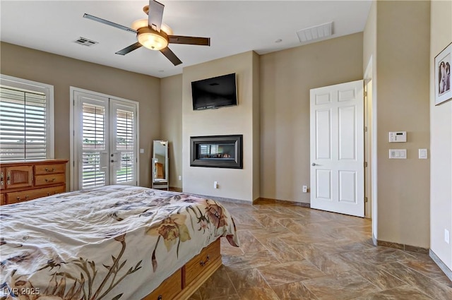 bedroom with baseboards, visible vents, access to exterior, and a glass covered fireplace