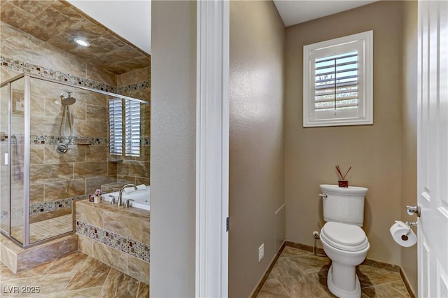 bathroom with tile patterned flooring, toilet, baseboards, a garden tub, and a stall shower