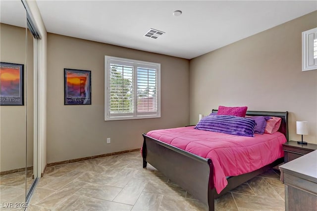 bedroom with baseboards and visible vents