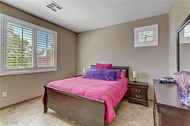 bedroom featuring visible vents and baseboards
