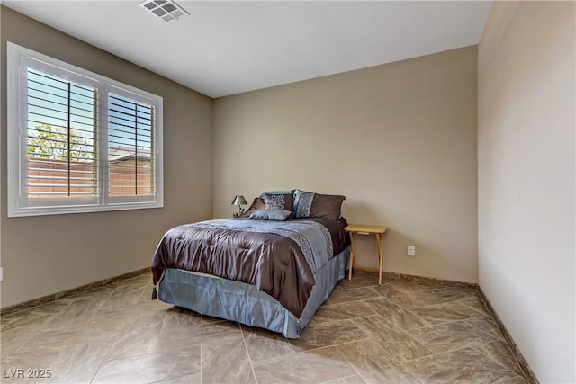 bedroom with baseboards and visible vents