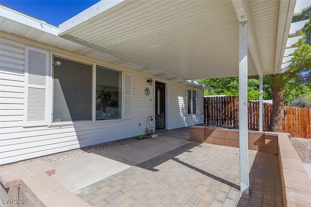 view of patio featuring fence