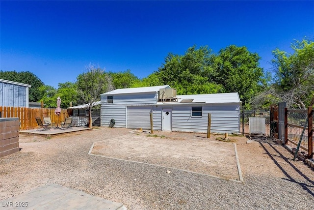 view of yard with an outdoor structure, a fenced backyard, and a deck