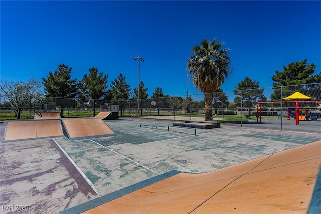 view of community with fence and a tennis court