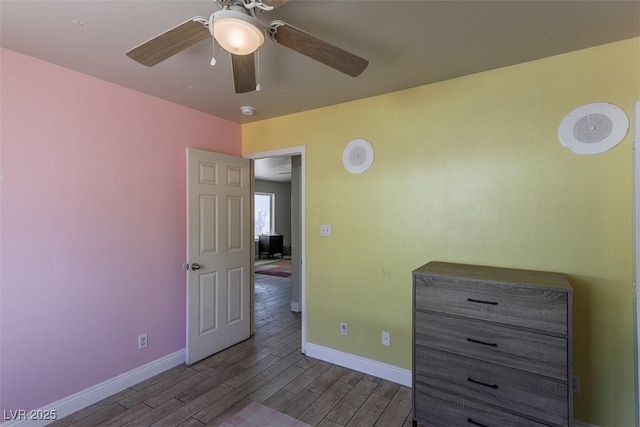 unfurnished bedroom with baseboards, ceiling fan, and wood finished floors