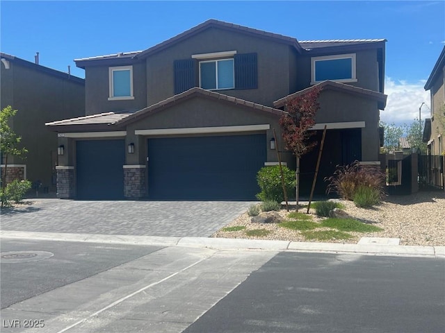 7527 Ardenno St, North Las Vegas, NV 89084 - traditional-style home with an attached garage, stucco siding, a tiled roof, and stone siding